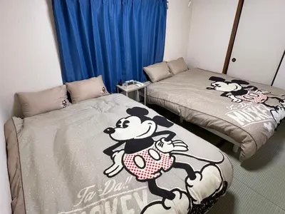 a room with two beds with winnie the pooh beds at Sepia Court Inn \u30bb\u30d4\u30a2\u30b3\u30fc\u30c8\u30a4\u30f3 in Urayasu