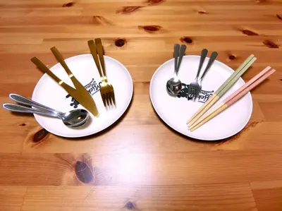 two white plates with chopsticks and forks and spoons at Sepia Court Inn \u30bb\u30d4\u30a2\u30b3\u30fc\u30c8\u30a4\u30f3 in Urayasu
