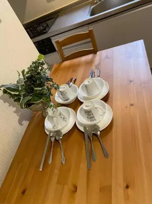 a table with plates and spoons on top of it at Takemura Building 107 in Tokyo