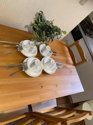 a wooden table with four dishes and a plant on it at Takemura Building 107 in Tokyo