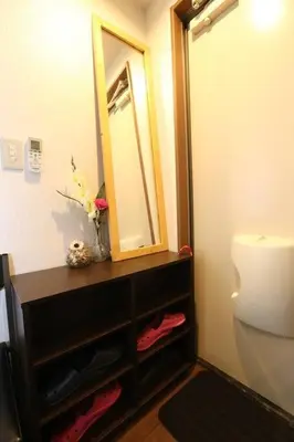 a bathroom with a vanity with a mirror and a toilet at Takemura Building 107 in Tokyo