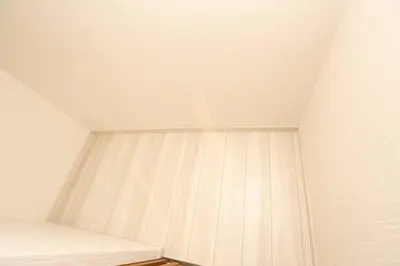 a ceiling in a room with white walls and wooden floors at Takemura Building 107 in Tokyo