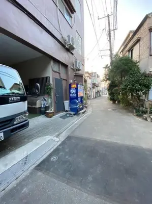 a van parked on a street next to a building at Takemura Building 107 in Tokyo