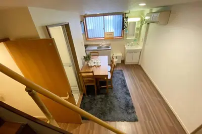 a small room with a table and a kitchen at Takemura Building 107 in Tokyo