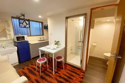a bathroom with a small table and two stools at Takemura Building106 in Tokyo