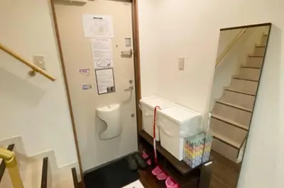 a bathroom with a toilet and a stair case at Takemura Building106 in Tokyo