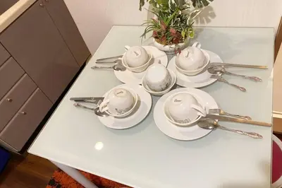 a white table with spoons and dishes on it at Takemura Building106 in Tokyo