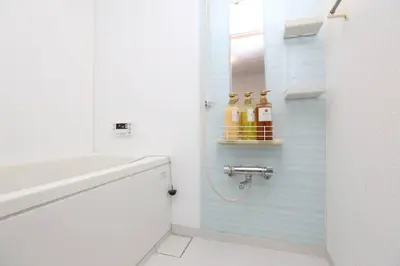 a white bathroom with a sink and a mirror at Takemura Building106 in Tokyo