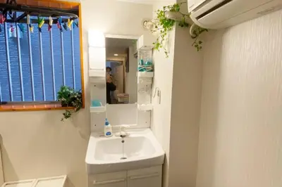 a bathroom with a sink and a mirror at Takemura Building 105 in Tokyo