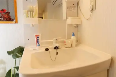 a white sink in a bathroom with a mirror at Takemura Building 105 in Tokyo