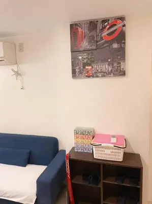 a living room with a blue couch and a table at Takemura Building 105 in Tokyo