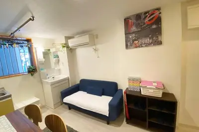 a small room with a blue chair and a table at Takemura Building 105 in Tokyo