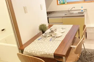 a small kitchen with a table and a sink at Takemura Building 105 in Tokyo