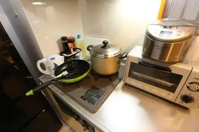 a kitchen counter with a stove with a pot on it at Takemura Building 105 in Tokyo