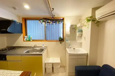 a small kitchen with a sink and a window at Takemura Building 105 in Tokyo