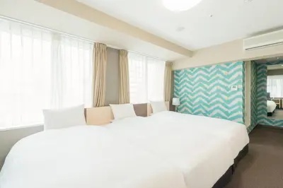two white beds in a room with windows at Rose Stay Tokyo Shiba Park in Tokyo