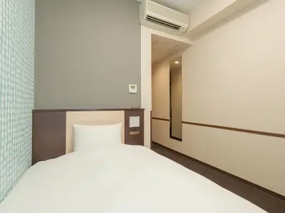 a bedroom with a white bed in a room at Rose Stay Tokyo Shiba Park in Tokyo