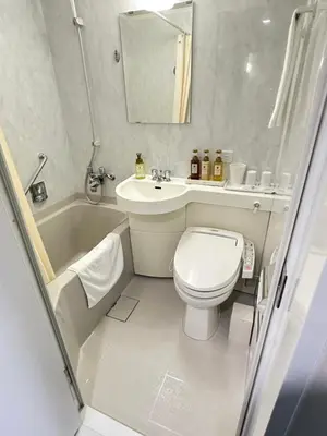 a bathroom with a toilet and a sink and a tub at Rose Stay Tokyo Shiba Park in Tokyo