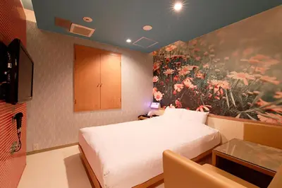 a bedroom with a bed and a painting on the wall at HOTEL555 \u9326\u7cf8\u753a in Tokyo