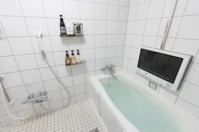 a bathroom with a tub and a tv on the wall at HOTEL555 \u9326\u7cf8\u753a in Tokyo