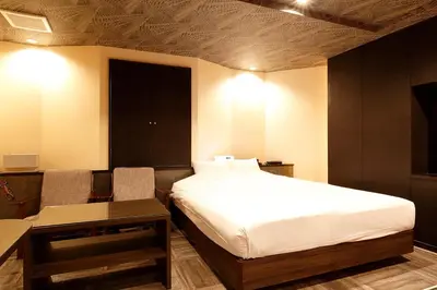 a hotel room with a bed and a table and a table sidx sidx at HOTEL555 \u9326\u7cf8\u753a in Tokyo