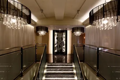 a hallway with chandeliers and stairs in a building at HOTEL555 \u9326\u7cf8\u753a in Tokyo