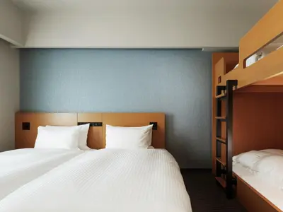a bedroom with two beds and a bunk bed at MIMARU Tokyo Station East in Tokyo