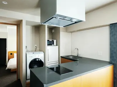 a kitchen with a sink and a refrigerator at MIMARU Tokyo Station East in Tokyo