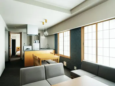a living room with a table and a kitchen at MIMARU Tokyo Station East in Tokyo
