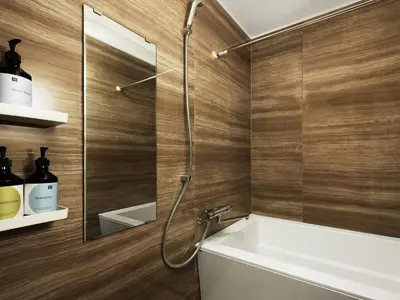 a bathroom with a shower with a sink and a mirror at MIMARU Tokyo Station East in Tokyo