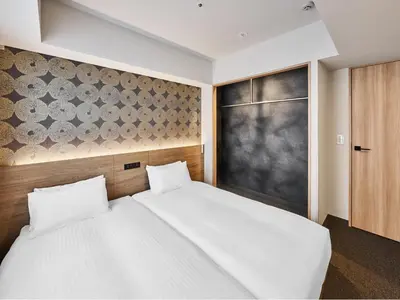 a bedroom with a large white bed and a black wall at MIMARU Tokyo Kinshicho in Tokyo