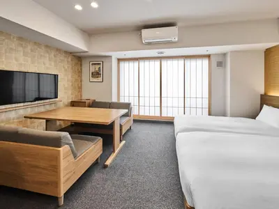 a hotel room with a bed and a table and a tv at MIMARU Tokyo Kinshicho in Tokyo