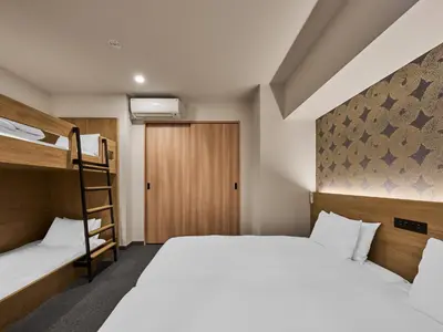 a bedroom with two bunk beds and a ladder at MIMARU Tokyo Kinshicho in Tokyo