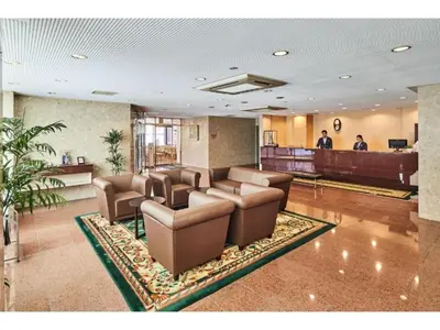 a waiting room with brown leather chairs and a waiting area at Urayasu Sun Hotel - Vacation STAY 33007v in Urayasu