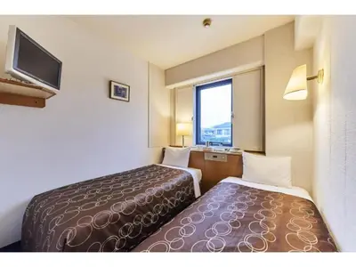 a hotel room with two beds and a television at Urayasu Sun Hotel - Vacation STAY 33015v in Urayasu