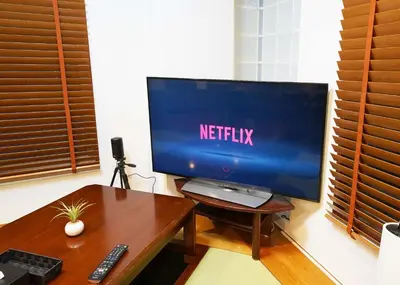 a flat screen tv sitting on a wooden table at \u9f8d\u99ac\u30b6\u30bf\u30ef\u30fc RYUMA The TOWER \u4e00\u68df\u8cb8\u5207\u306e\u5bbf in Tokyo