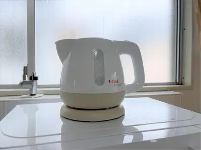 a white tea kettle sitting on a kitchen counter at LUANAHOTEL IN WASEDA in Tokyo