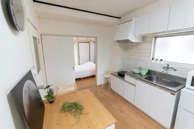 a kitchen with white cabinets and a sink at LUANAHOTEL IN WASEDA in Tokyo