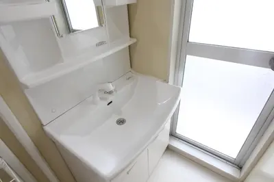 a white bathroom with a sink and a window at LUANAHOTEL IN WASEDA in Tokyo