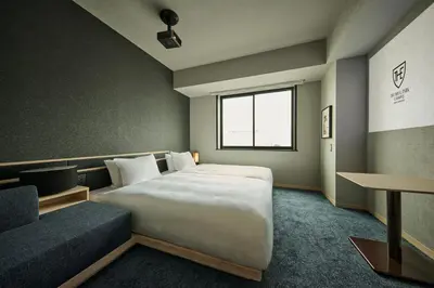 a bedroom with a large bed and a couch at The Royal Park Canvas Ginza Corridor in Tokyo