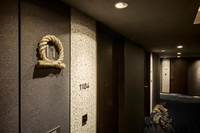 a hallway with a wreath on the wall at The Royal Park Canvas Ginza Corridor in Tokyo
