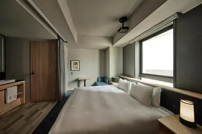 a large white bed in a room with a window at The Royal Park Canvas Ginza Corridor in Tokyo