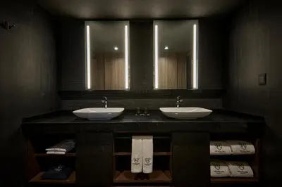 a bathroom with two sinks and two mirrors at The Royal Park Canvas Ginza Corridor in Tokyo