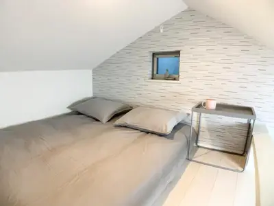 a bed in a room with a brick wall at KIKO HOUSE - Vacation STAY 42470v in Tokyo
