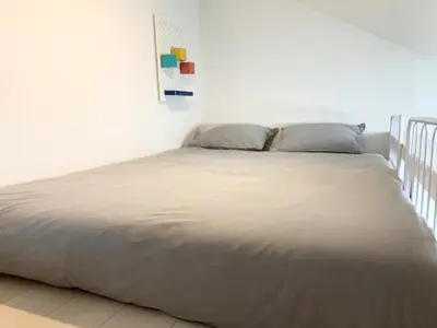 a large bed in a bedroom with a white wall at KIKO HOUSE - Vacation STAY 42464v in Tokyo