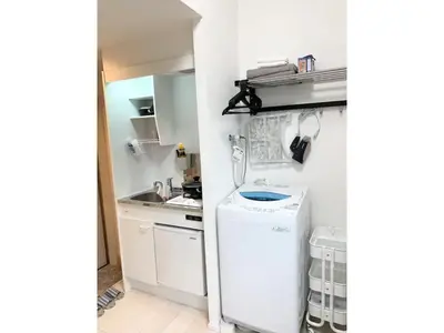 a small kitchen with a white refrigerator and a washer at KIKO HOUSE - Vacation STAY 42464v in Tokyo