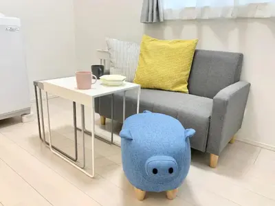 a living room with a chair and a table with a pig toy at KIKO HOUSE - Vacation STAY 42464v in Tokyo