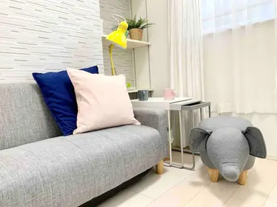 a living room with a couch with a stuffed elephant on it at KIKO HOUSE - Vacation STAY 42467v in Tokyo