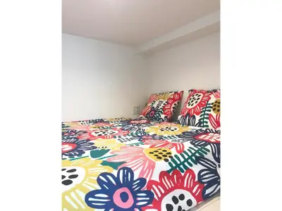 a bedroom with a bed with a colorful bedspread at KIKO HOUSE - Vacation STAY 42456v in Tokyo