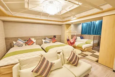 a bedroom with two beds and a couch at Hotel BaliAn Resort Shinjuku Glamping in Tokyo